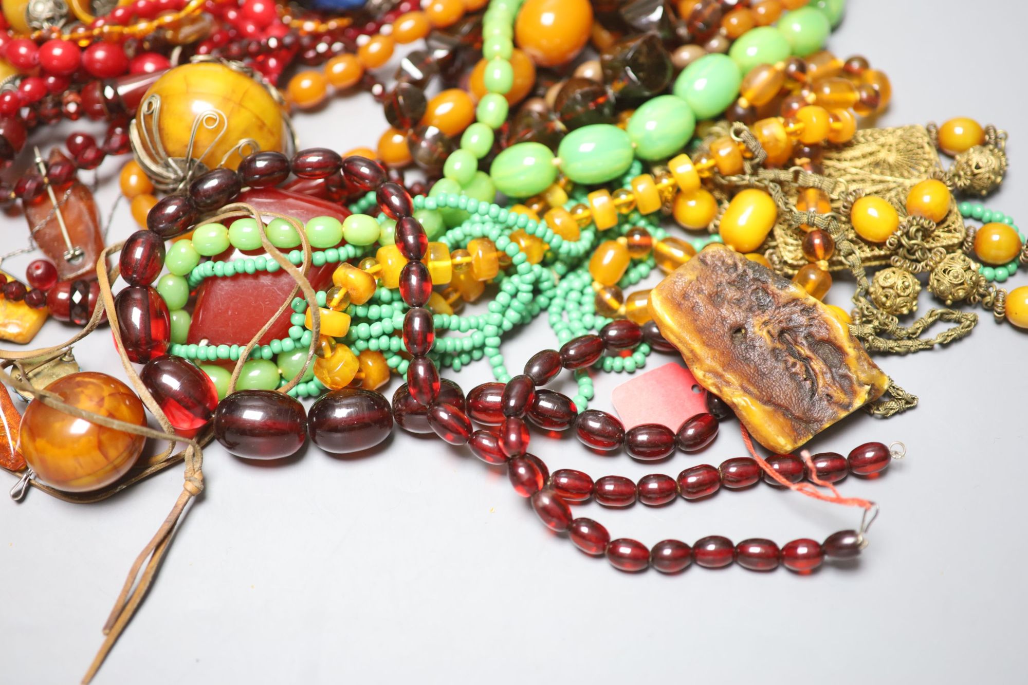 A group of assorted costume jewellery including faux amber etc.